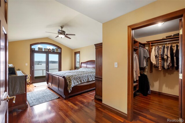 11589 Ember, Davisburg, MI 48350 - bedroom featuring access to exterior, wood finished floors, vaulted ceiling, a spacious closet, and baseboards