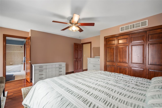 11589 Ember, Davisburg, MI 48350 - bedroom with wood finished floors, a closet, a ceiling fan, and connected bathroom