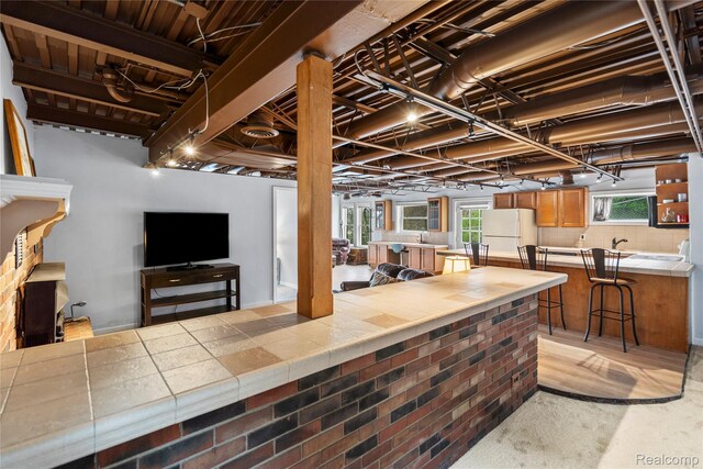 11589 Ember, Davisburg, MI 48350 - below grade area with freestanding refrigerator and a sink