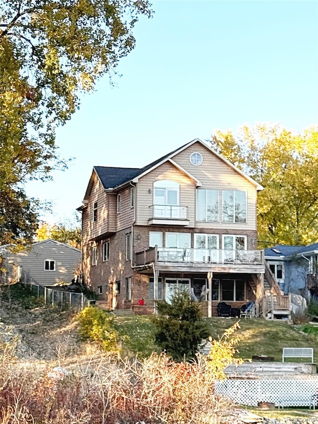 11589 Ember, Davisburg, MI 48350 - back of house featuring a wooden deck and a balcony