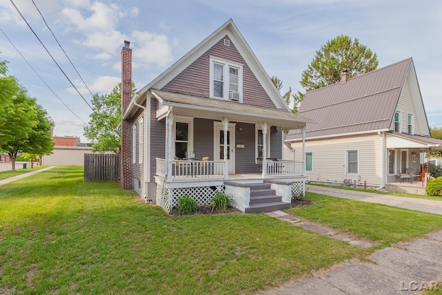 134 W Lagrange St, Morenci, MI 49256 - view of front of house with a porch, a chimney, and a front lawn