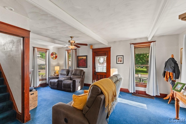 134 W Lagrange St, Morenci, MI 49256 - carpeted living area with healthy amount of natural light, beamed ceiling, stairs, baseboards, and a ceiling fan