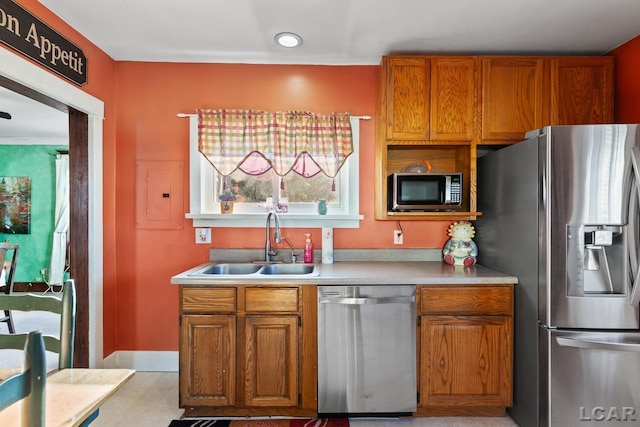 134 W Lagrange St, Morenci, MI 49256 - kitchen with stainless steel appliances, a sink, light countertops, electric panel, and brown cabinets