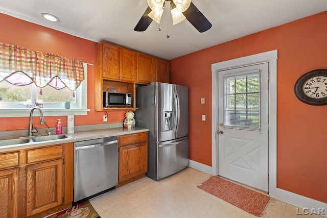 134 W Lagrange St, Morenci, MI 49256 - kitchen with stainless steel appliances, a sink, light countertops, a ceiling fan, and brown cabinetry