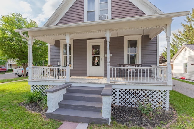 134 W Lagrange St, Morenci, MI 49256 - view of front of house featuring covered porch and a front lawn