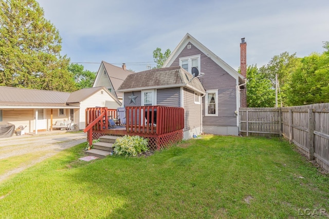 134 W Lagrange St, Morenci, MI 49256 - back of property with a deck, a chimney, and a shingled roof
