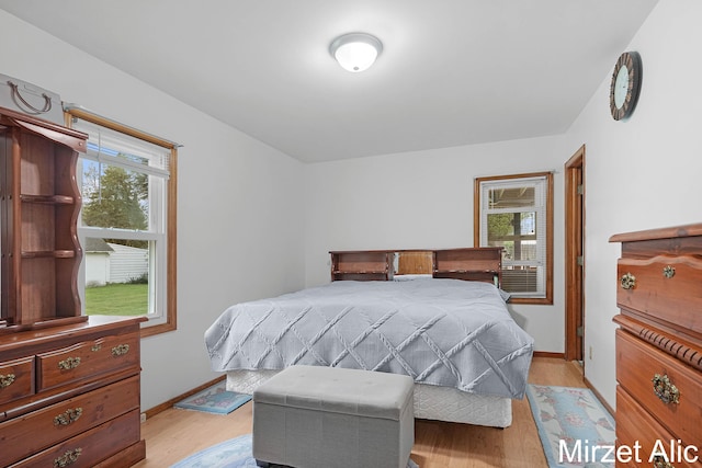 1145 Eastmont Dr SE, Grand Rapids, MI 49546 - bedroom featuring multiple windows, light wood-style floors, and baseboards