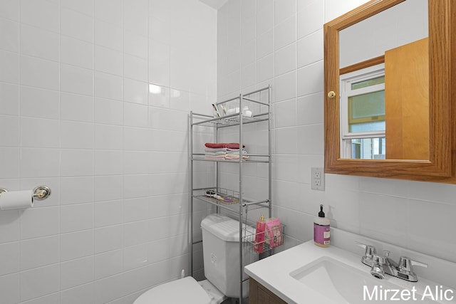 1145 Eastmont Dr SE, Grand Rapids, MI 49546 - bathroom featuring tile walls, toilet, and vanity