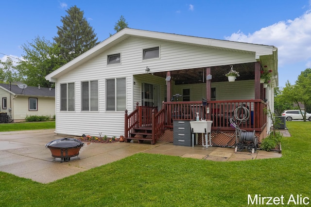 1145 Eastmont Dr SE, Grand Rapids, MI 49546 - back of house featuring an outdoor fire pit, a lawn, and a patio