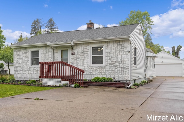 1145 Eastmont Dr SE, Grand Rapids, MI 49546 - view of front facade with stone siding, a chimney, an outdoor structure, and roof with shingles