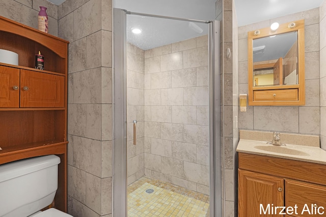 1145 Eastmont Dr SE, Grand Rapids, MI 49546 - bathroom featuring vanity, a shower stall, toilet, and tile walls