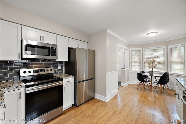 2376 Bacon Ave, Berkley, MI 48072 - kitchen with appliances with stainless steel finishes, baseboards, light stone countertops, crown molding, and tasteful backsplash