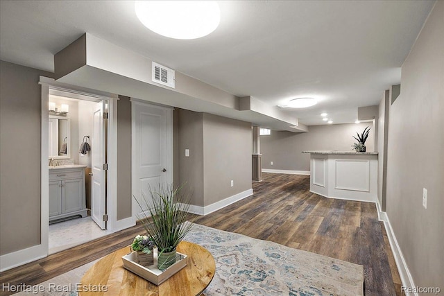 2376 Bacon Ave, Berkley, MI 48072 - living room with baseboards, dark wood-type flooring, and bar