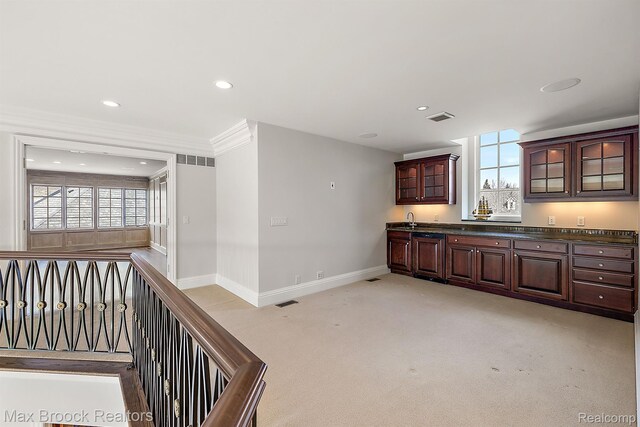 2921 Turtle Pond Ct, Bloomfield Hills, MI 48302 - kitchen with dark countertops, light colored carpet, baseboards, glass insert cabinets, and dark brown cabinets