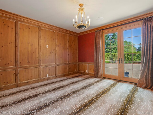 2921 Turtle Pond Ct, Bloomfield Hills, MI 48302 - unfurnished room featuring a chandelier, french doors, carpet flooring, a decorative wall, and crown molding
