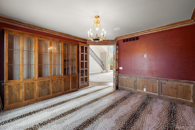 2921 Turtle Pond Ct, Bloomfield Hills, MI 48302 - unfurnished dining area featuring carpet floors, a chandelier, stairs, ornamental molding, and wainscoting