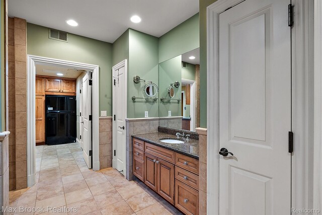 2921 Turtle Pond Ct, Bloomfield Hills, MI 48302 - bathroom featuring tile walls, vanity, recessed lighting, and tile patterned flooring