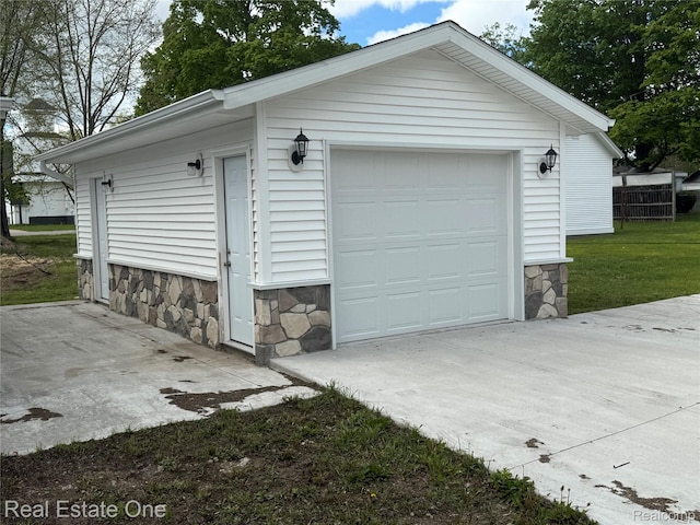206 W 4th St, Kalkaska, MI 49646 - detached garage featuring driveway