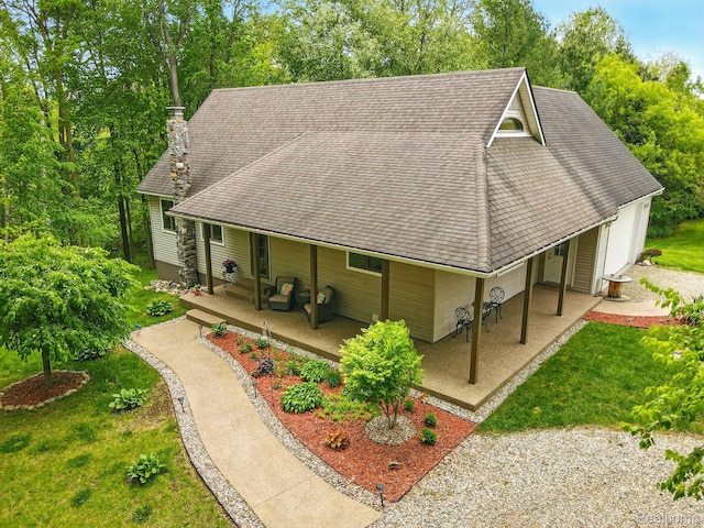 5960 Kidder Rd, Almont, MI 48003 - view of front of house featuring roof with shingles, a chimney, a front yard, and a porch