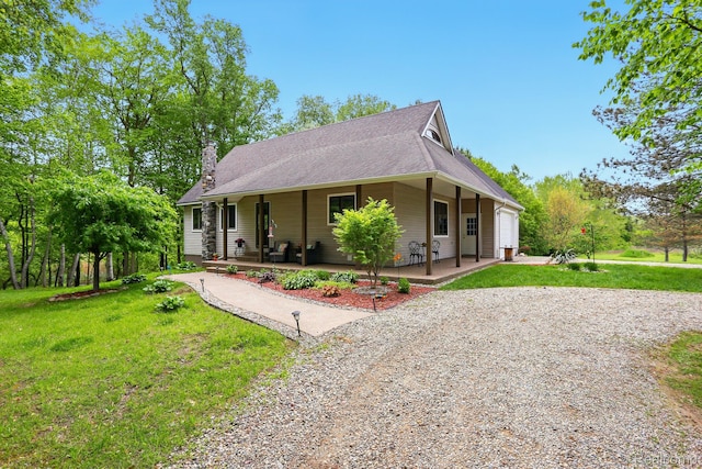 5960 Kidder Rd, Almont, MI 48003 - country-style home with gravel driveway, covered porch, an attached garage, a front lawn, and roof with shingles