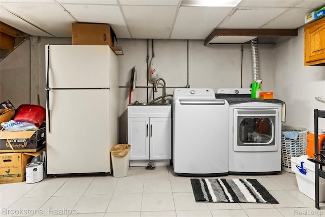 4328 15 Mile Rd, Sterling Heights, MI 48310 - laundry area featuring washing machine and dryer, cabinet space, and light tile patterned flooring
