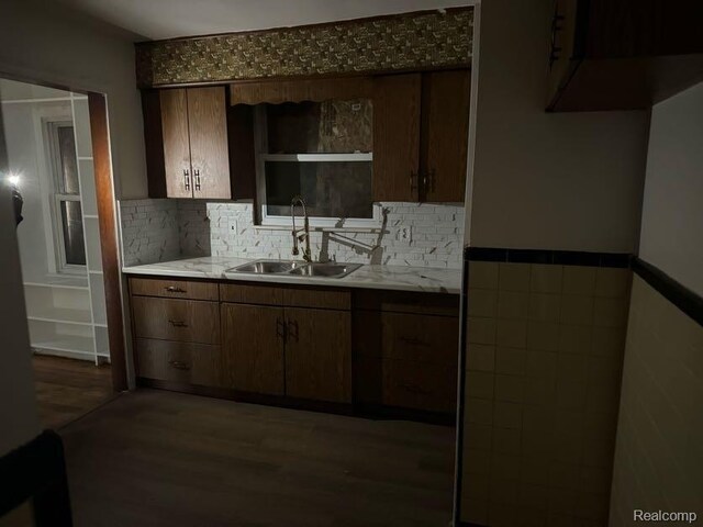 13801 Fordham St, Detroit, MI 48205 - kitchen featuring a sink, wood finished floors, light countertops, tasteful backsplash, and a wainscoted wall