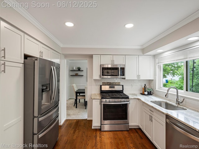 5544 Kingsfield Dr, West Bloomfield, MI 48322 - kitchen featuring stainless steel appliances, a sink, light stone countertops, white cabinetry, and ornamental molding