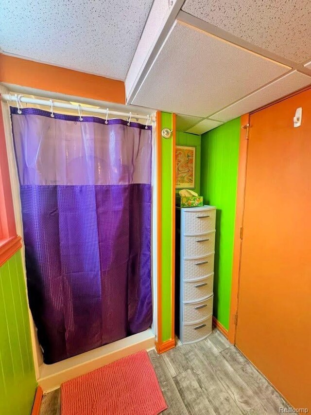 219 W Butler St, Bad Axe, MI 48413 - full bath with wood finished floors and a shower with shower curtain