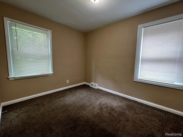 8260 Coyle St, Detroit, MI 48228 - empty room with dark carpet and baseboards