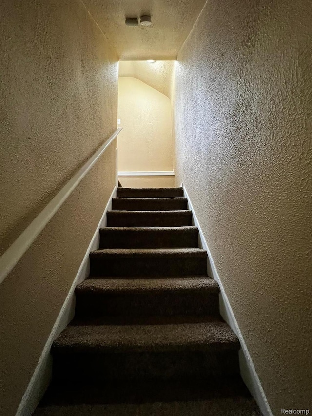 8260 Coyle St, Detroit, MI 48228 - stairs with a textured wall and vaulted ceiling