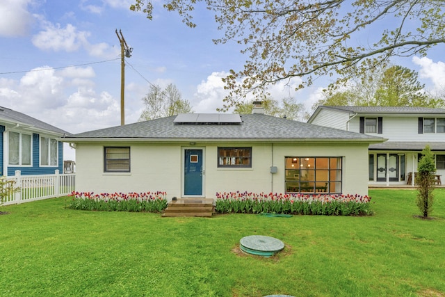 5810 N Lakeshore Rd, Deckerville, MI 48427 - view of front of house with entry steps, solar panels, roof with shingles, a chimney, and concrete block siding