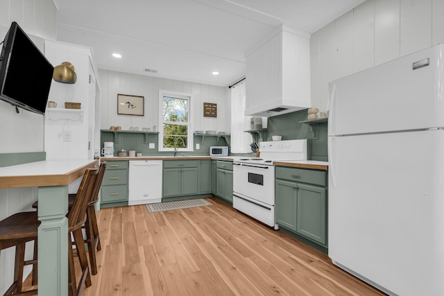 5810 N Lakeshore Rd, Deckerville, MI 48427 - kitchen with green cabinetry, white appliances, light wood-style floors, open shelves, and a sink