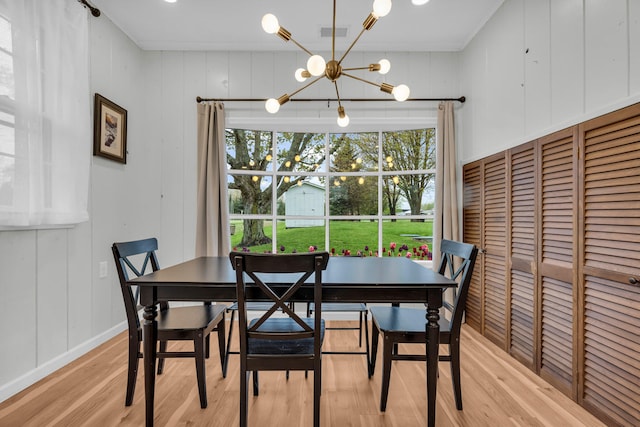 5810 N Lakeshore Rd, Deckerville, MI 48427 - dining area featuring a chandelier, light wood-type flooring, and baseboards