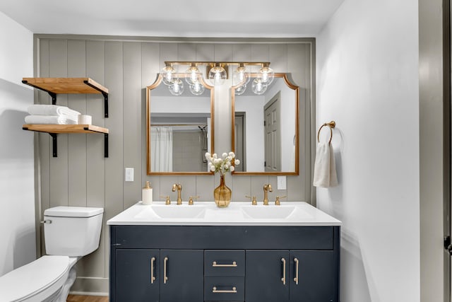 5853 W 112th St, Grant, MI 49327 - full bathroom with double vanity, toilet, a chandelier, and wood finished floors