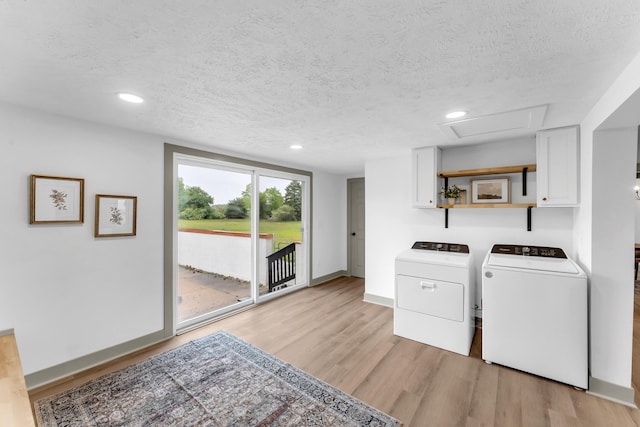 5853 W 112th St, Grant, MI 49327 - laundry area with washer and clothes dryer, light wood finished floors, baseboards, a textured ceiling, and attic access
