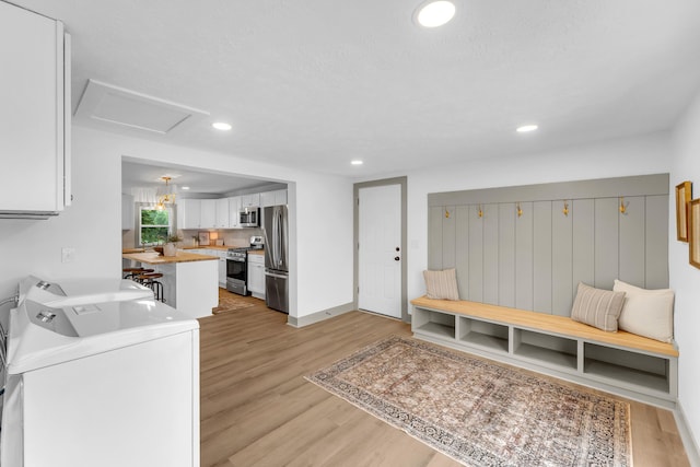 5853 W 112th St, Grant, MI 49327 - mudroom featuring washer and dryer, light wood-type flooring, recessed lighting, and baseboards