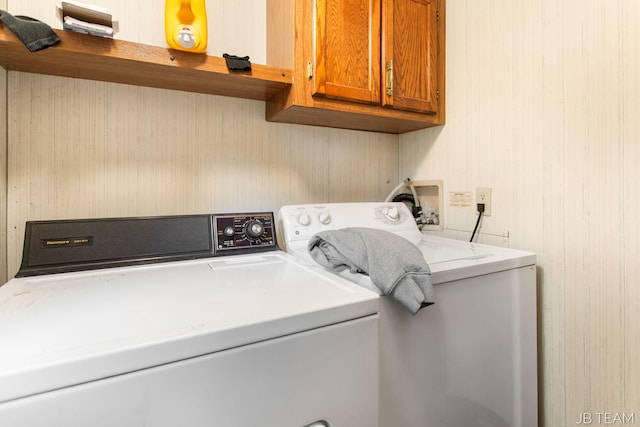 1211 107th Ave, Otsego, MI 49078 - washroom featuring cabinet space, washing machine and clothes dryer, and wooden walls