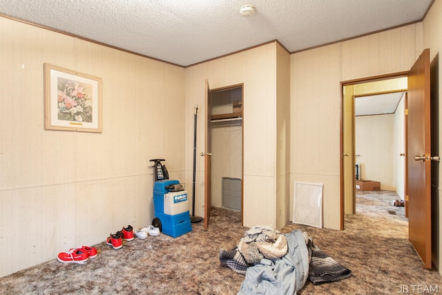 1211 107th Ave, Otsego, MI 49078 - unfurnished bedroom with carpet, crown molding, and a textured ceiling