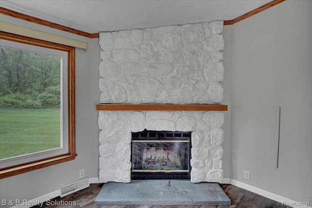 5951 English Rd, Silverwood, MI 48760 - detailed view of baseboards, a textured ceiling, wood finished floors, crown molding, and a fireplace