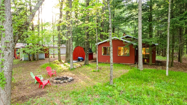 17341 Old Logging Rd, Hersey, MI 49639 - view of yard with an outdoor fire pit and an outbuilding