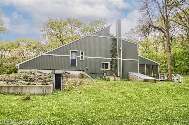 12445 Shaffer Rd, Davisburg, MI 48350 - back of property with a yard and a sunroom