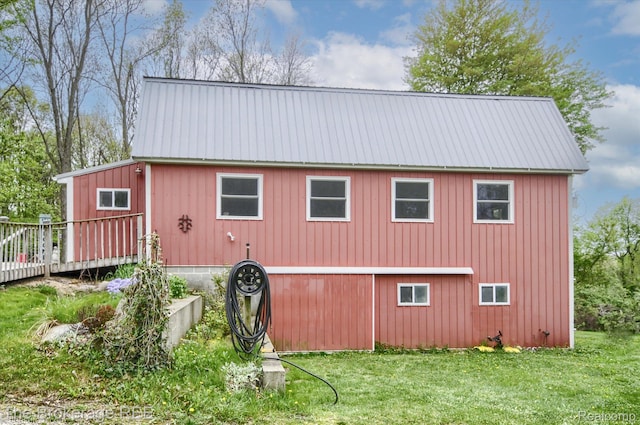 12445 Shaffer Rd, Davisburg, MI 48350 - view of side of property with metal roof, a yard, and a deck