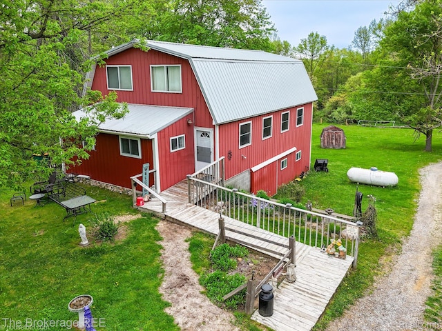 12445 Shaffer Rd, Davisburg, MI 48350 - view of front facade with metal roof, a gambrel roof, a front lawn, and a garage