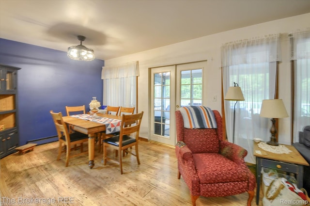 12445 Shaffer Rd, Davisburg, MI 48350 - dining area with wood finished floors and a baseboard radiator
