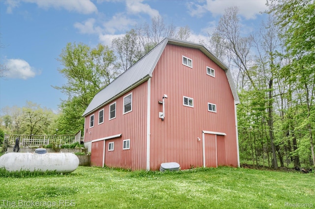 12445 Shaffer Rd, Davisburg, MI 48350 - view of side of property with a lawn, a detached garage, metal roof, a barn, and an outdoor structure