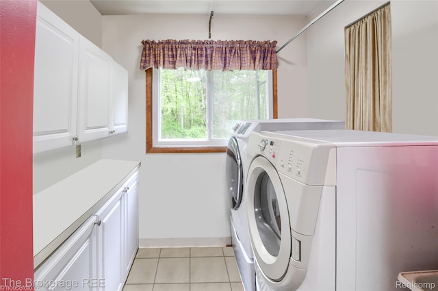 12445 Shaffer Rd, Davisburg, MI 48350 - laundry room featuring cabinet space, washing machine and clothes dryer, light tile patterned floors, and baseboards