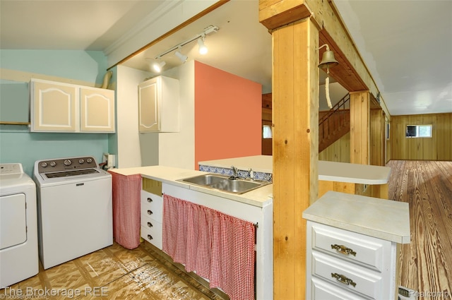 12445 Shaffer Rd, Davisburg, MI 48350 - washroom with a sink, rail lighting, washer and dryer, and wood walls