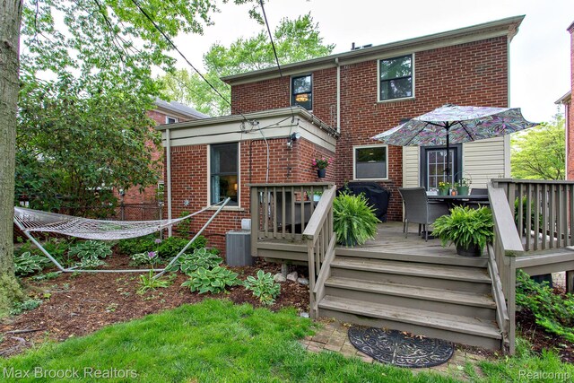 13317 Victoria Ave, Huntington Woods, MI 48070 - rear view of house with brick siding, a wooden deck, and outdoor dining area