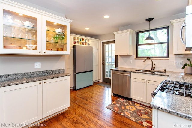 13317 Victoria Ave, Huntington Woods, MI 48070 - kitchen with appliances with stainless steel finishes, a sink, white cabinets, wood finished floors, and recessed lighting