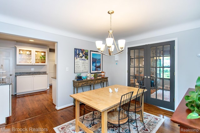 13317 Victoria Ave, Huntington Woods, MI 48070 - dining space featuring french doors, dark wood-type flooring, and a chandelier